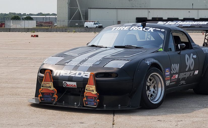 Eric Anderson SSM Miata showing off SCCA Solo Nationals Trophies
