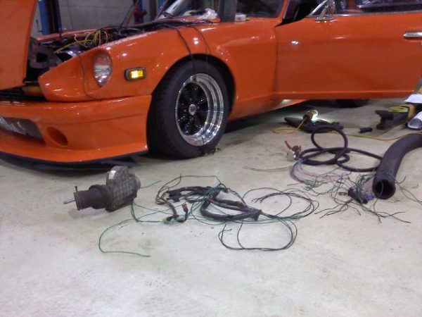 Datsun 280Z with air flow meter removed along with related wiring in preparation for standalone ECU installation.