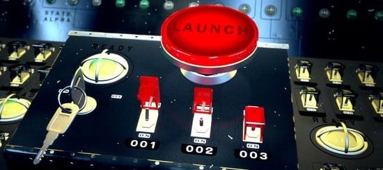 Large red launch control button on switchboard