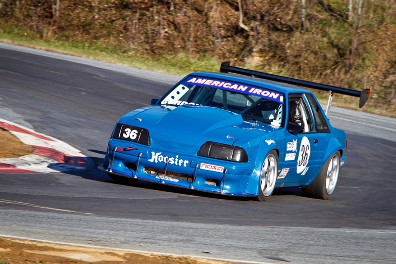 Fox Body Mustang doing Fox Body Mustang things on a road course